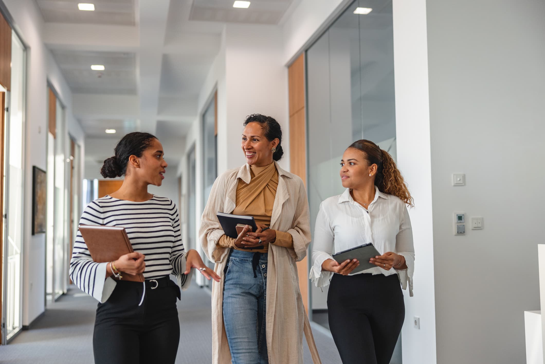 a man and a woman holding a tablet in front of farm equipment