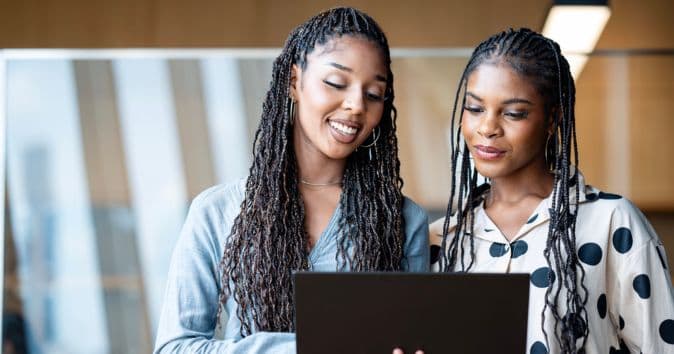 women reading on laptop