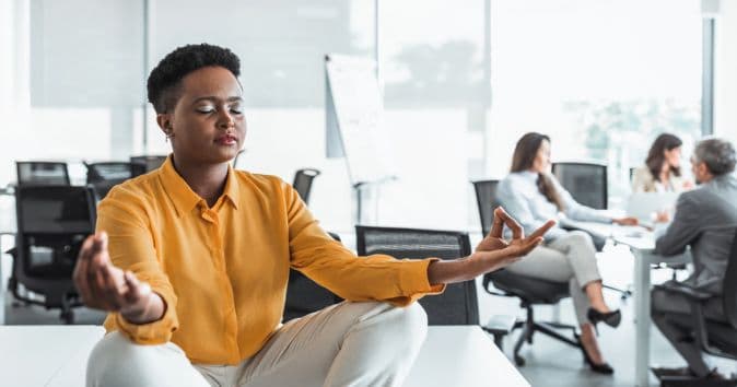 woman meditating at desk